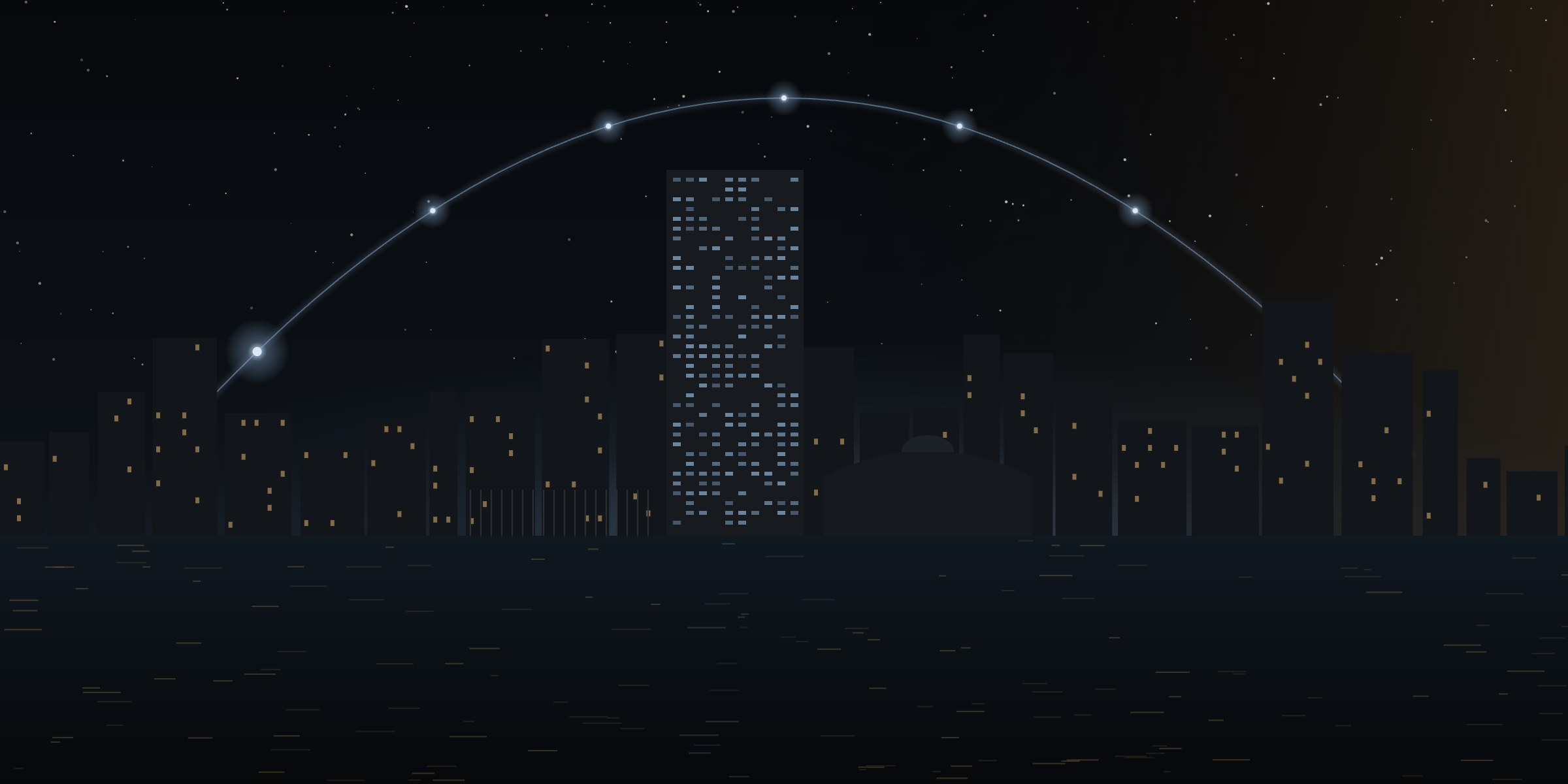 The New York skyline and the UN Secretariat over the East River at night, under an arc of seven lights.